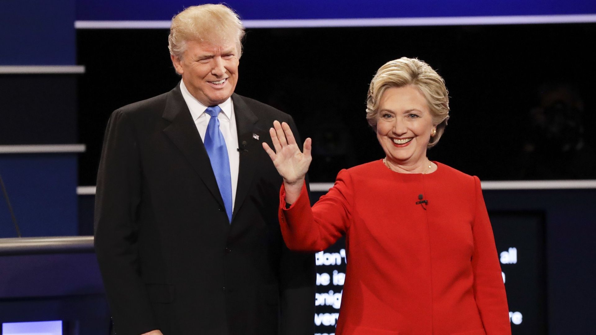 Donald Trump and Hillary Clinton smiling at a public event.