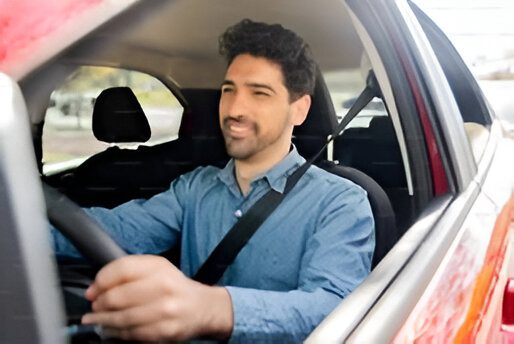 Man driving a car, focused on the road.